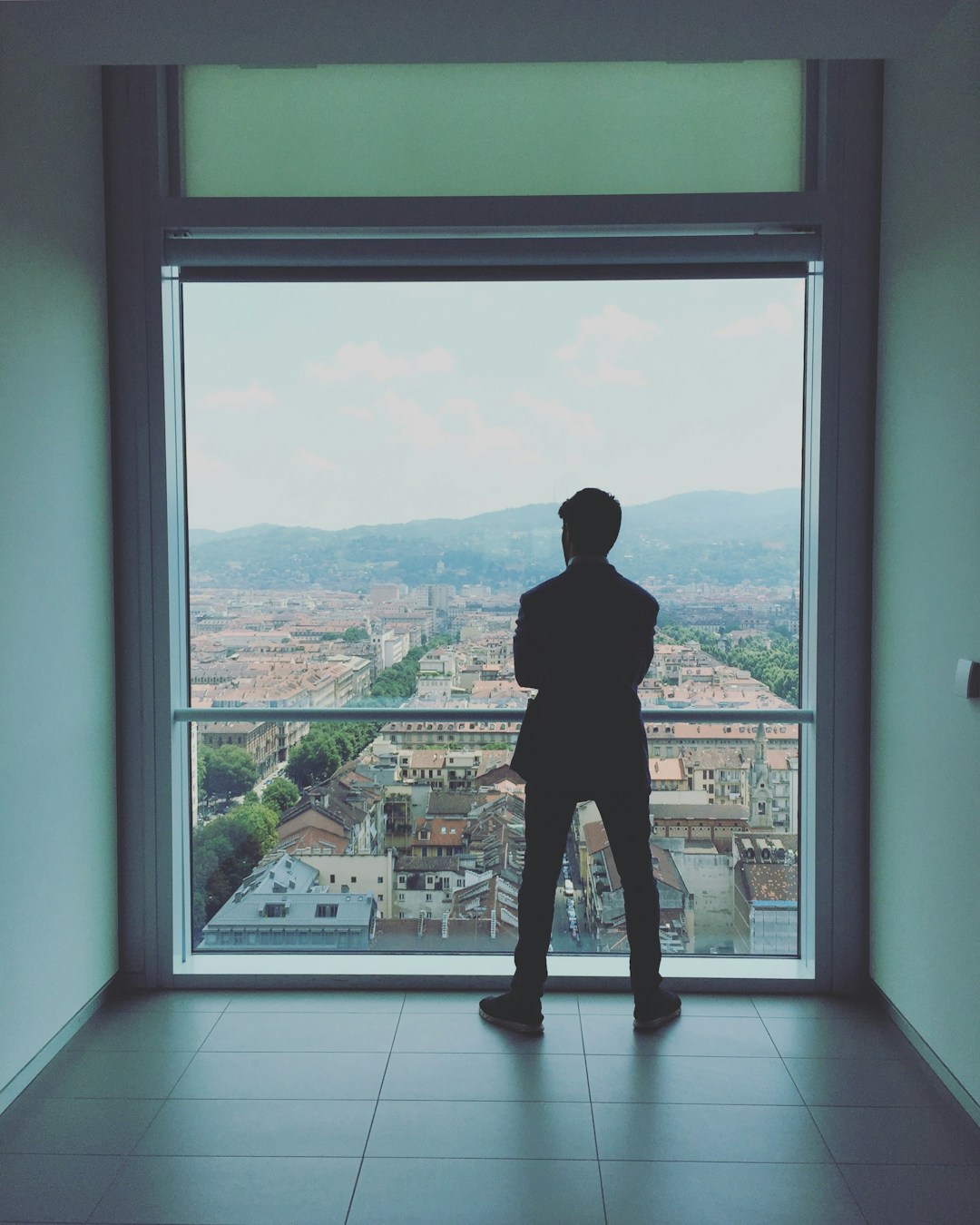 Business executive looking over a city from a modern building